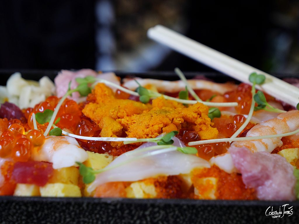 A tasty looking Sashimi Bento from Daimaru Department Store in Tokyo on the fold down tray of the Shinkansen